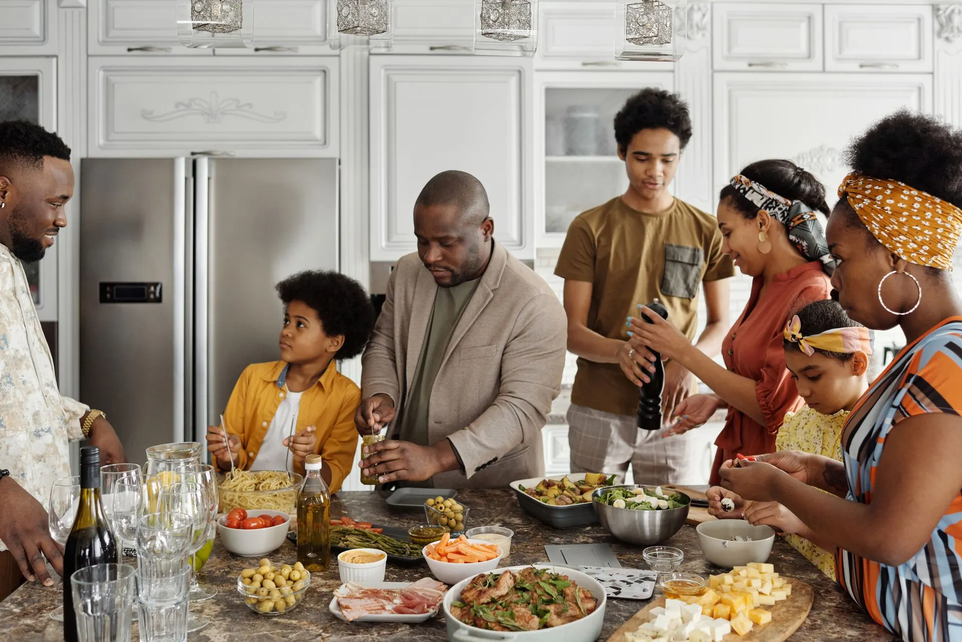 A family cooking dinner together around a kitchen island