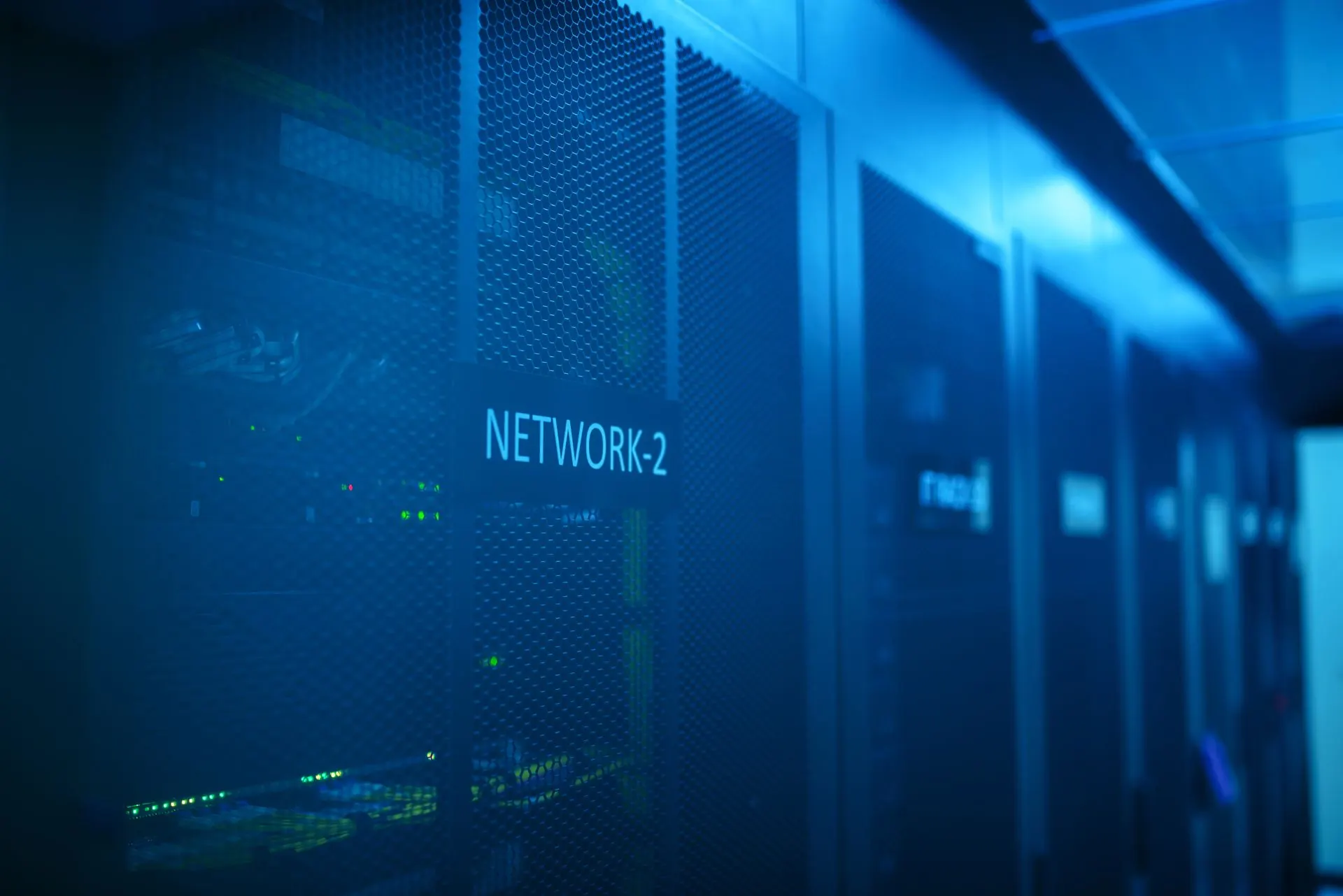 Blue-lit network racks in a server room
